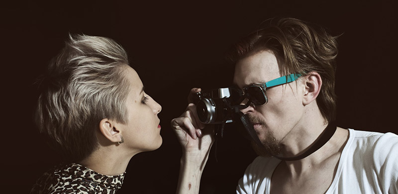 Man photographing a young woman in the studio